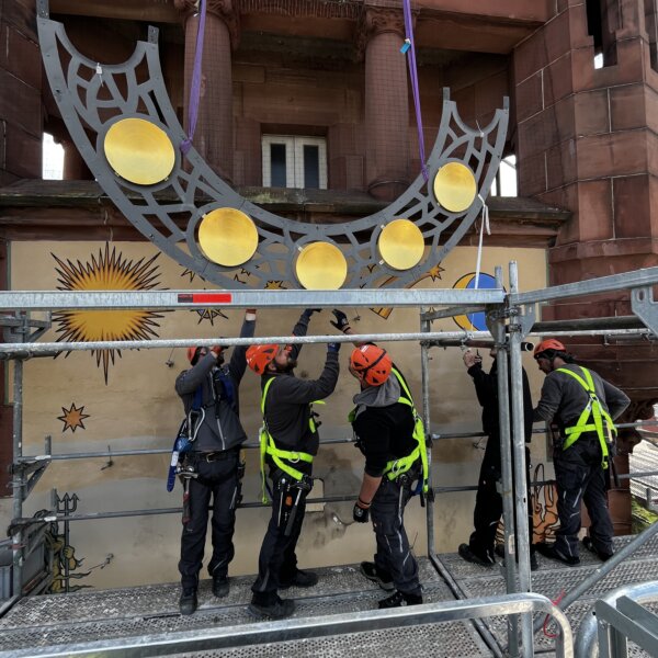 Team von Otto Wolf Gerüstbau bei der Demontage des Zifferblatts am Bezirksamtsturm Pforzheim – Spezialgerüstbau für historische Gebäude